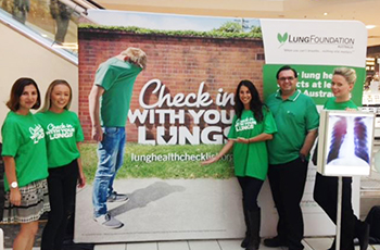 charity cups donation partners lung foundation in front of sign
