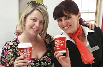 ladies holding hotels.com advertised coffee cup