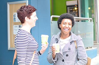 ladies holding QSuper advertised coffee cup